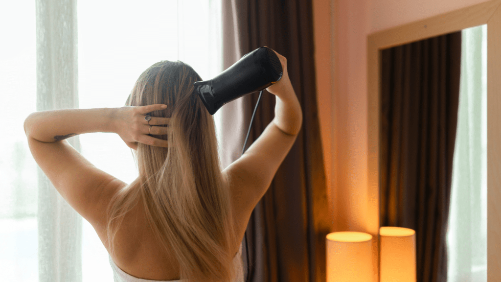 Woman use hair blower 