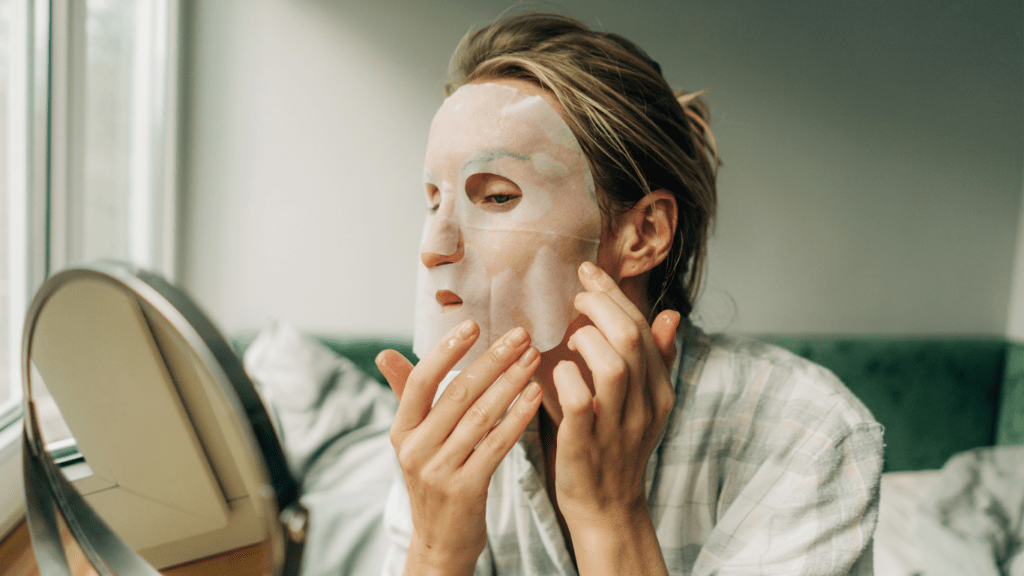 Woman putting facial mask for hydration